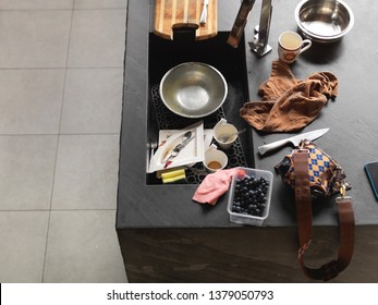 Overhead Shot Of A Messy Kitchen With Household Objects Spread Out On A Table