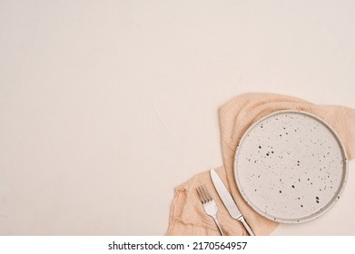 Overhead Shot, Minimal White Ceramic Plate Mockup, Cutlery, Beige Napkin And Copy Space For Product Or Text Display On White Background.