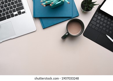 Overhead shot of mock up laptop, tablet, notebook, coffee cup and copy space on white table. - Powered by Shutterstock