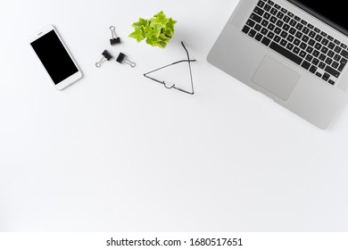 Overhead Shot Of Modern Workspace Concept With Laptop And Business Accessories On White Background With Copyspace. Office Desktop. Flat Lay