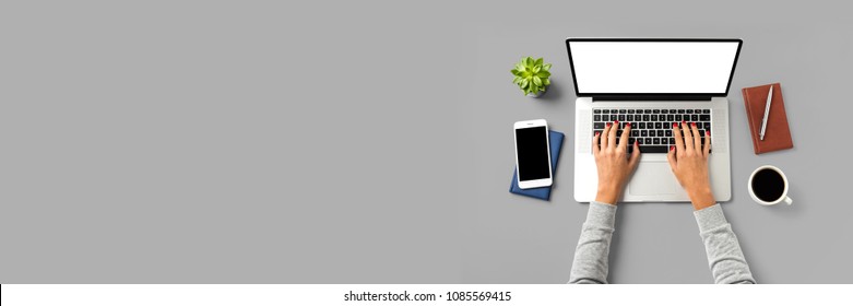 Overhead Shot Of Office Desktop With Female Hands Working On Modern Laptop