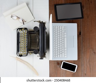 Overhead Shot Of And Old Fashioned Desk With Typewriter And Quill Pen Back-to-back With A Modern Set Up With Laptop Computer, Tablet And Cell Phone, (Phone And Tablet Created In Photoshop - Not Real)