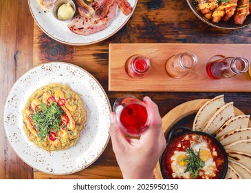 Overhead Shot Of A Person Grabbing A Drink From A Table During Brunch