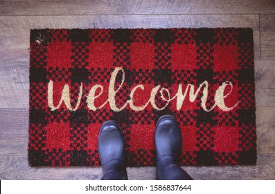 An overhead shot of a person standing on a welcome mat - Powered by Shutterstock