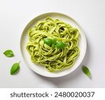 Overhead shot of pesto pasta Linguini on on a modern plate isolated on white background, food blog, Italian food, Pasta al pesto