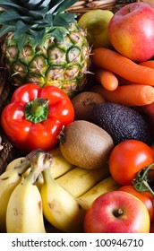 Overhead shot of a selection of fresh fruit and vegetables in a wicker basket.  Portrait orientation.