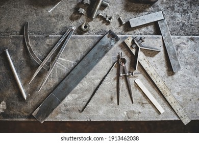 Overhead Shot Of A Selection Of Metal Work Tools On A Worn Metal Workbench