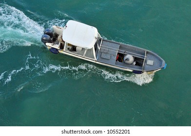 Overhead Shot Of A Small Motor Boat Traversing The Sea