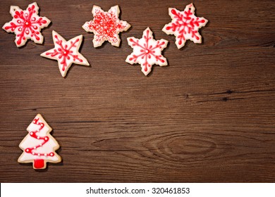 Overhead Shot Of A Snow And Christmas Tree Cookies On A Wooden Background.