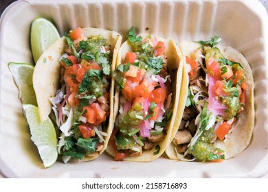 An Overhead Shot Of Street Tacos With Limes In Take Away Box