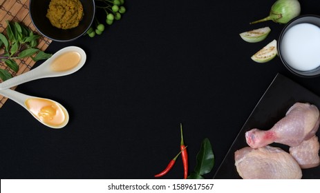 Overhead Shot Of Thai Food Ingredients And Herbs For Chicken Green Curry On Black Background