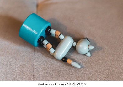 An Overhead Shot Of A Toy Cat On A Blue Podium Thrown On A Beige Material