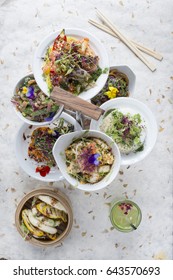 Overhead Shot Of Various Meals In Plates Placed In Tiered Server