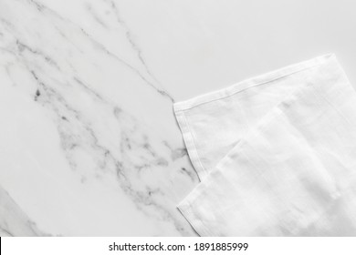Overhead Shot Of A White Linen Napkin On A White Marble Kitchen Counter With Room For Text.