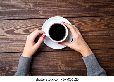 Overhead Shot Of Woman's Hands Holding Cup Of Coffee