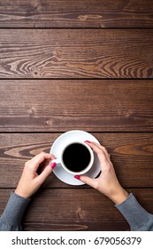 Overhead Shot Of Woman's Hands Holding Cup Of Coffee