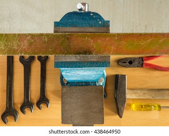 An Overhead Shot Of A Work Bench With Tools And A Vice