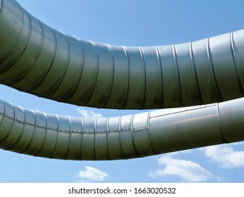 Overhead Steel Pipeline With Aluminum Shroud Covered Gas Or Heating Supply Tubes. Blue Sky. Natural Gas Supply Shortage And Energy Supply Security Concept. Europe, Russia, Germany. Gas Supply Stop.