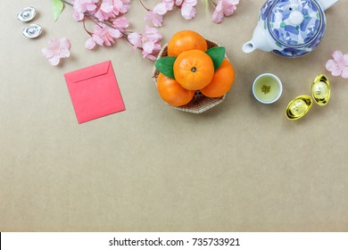 Overhead of top decorations Chinese New Year festive background concept.Mix variety essential accessory on modern grunge brown table house office desk.Other language mean rich or wealthy and happy.