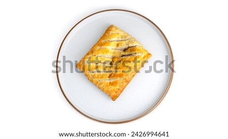 Overhead top down view of bake pastry Isolated on a plate. baked pastry with white background, no people and copy space. Golden yellow and brown pastry.