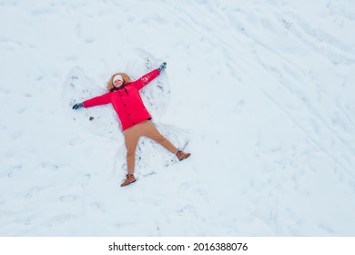 Overhead Top View Of Man Making Snow Angel Copy Space