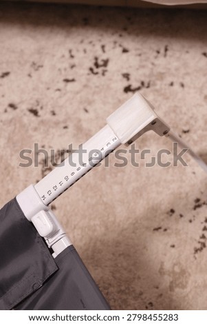 Overhead view of an adjustable bed rail leg with a folding lock mechanism.
