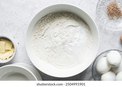 overhead view of All purpose flour in a white bowl, baking flour in a bowl