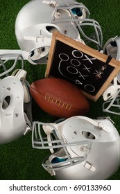 Overhead View Of American Football Amidst Sports Helmet On Field