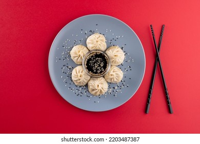 Overhead View Of Asian Dumplings, Soy Sauce And Chopsticks On Red Background. Asian Tasty Home Cooked Food And Healthy Eating.