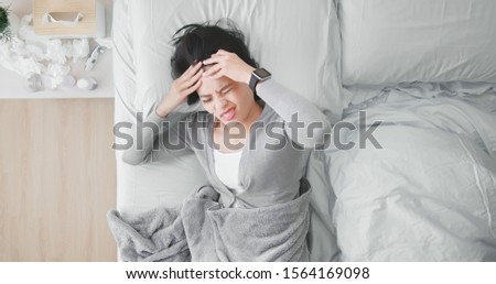 Overhead View of asian woman get sick and has headache lying on the bed