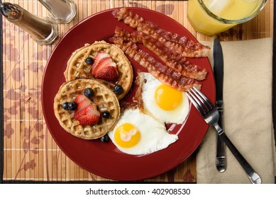 Overhead View Of Bacon And Fried Eggs With Multi-grain Waffles