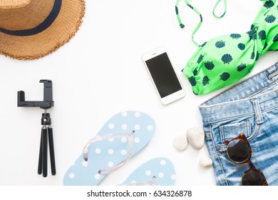 Overhead View Of Beach Items And Smart Phone, Summer  Concept On White Background With Copy Space, Flat Lay