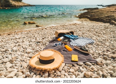 Overhead View Of Beach Stuff Blanket With Sun Protection Cream Straw Hat With Bag Flat Lay