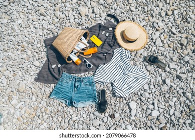 Overhead View Of Beach Stuff Blanket With Sun Protection Cream Straw Hat With Bag Flat Lay