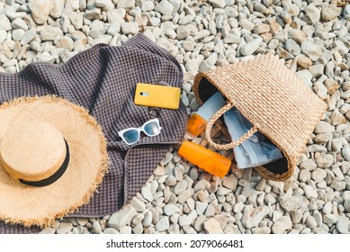 Overhead View Of Beach Stuff Blanket With Sun Protection Cream Straw Hat With Bag Flat Lay