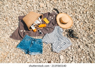 Overhead View Of Beach Stuff Blanket With Sun Protection Cream Straw Hat With Bag Flat Lay