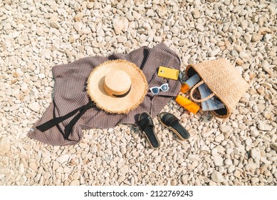 Overhead View Of Beach Stuff Blanket With Sun Protection Cream Straw Hat With Bag Flat Lay