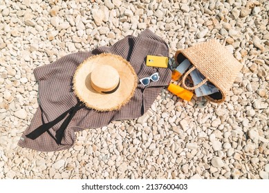 Overhead View Of Beach Stuff Blanket With Sun Protection Cream Straw Hat With Bag Flat Lay