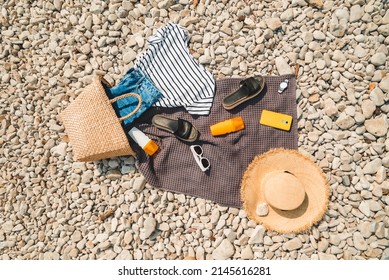 Overhead View Of Beach Stuff Blanket With Sun Protection Cream Straw Hat With Bag Flat Lay