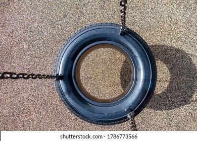Overhead View Of Black Chain Tire Swing At A Children's  Play Ground No People
