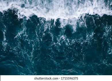 Overhead view to blue stormy ocean waves with white foam. - Powered by Shutterstock