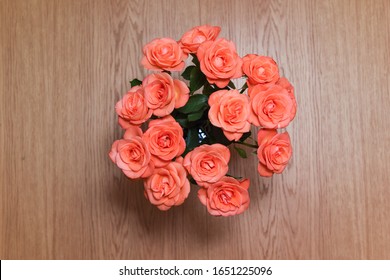 Overhead View Of A Bouquet Of Pink Roses On A Wooden Table