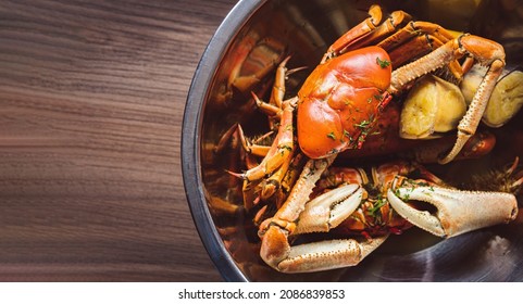 Overhead View Of A Bowl With Crabs Cooked With Ripe Bananas On A Wooden Table With Copy Space. Typical Food Of Ecuador