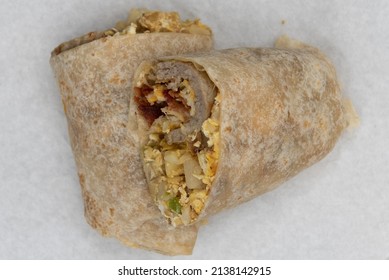 Overhead View Of Breakfast Burrito Cut In Half To Show All The Goodness Contained Inside The Tortilla.