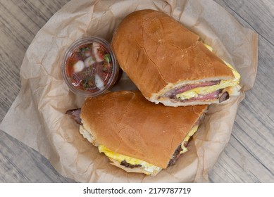 Overhead View Of Breakfast Steak And Scrambled Eggs Sandwich Loaded With Protein And Wrapped In An Italian Roll.