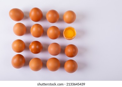 Overhead View Of Brown Eggs With One Broken Egg Arranged In Square On Table With Blank Space. Unaltered, Healthy Food, Raw Food, Organic, Protein, Fresh, Egg Yolk, Copy Space And Still Life.