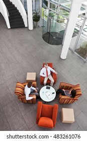 Overhead View Of Business Meeting In Office Atrium