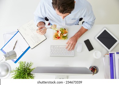 Overhead View Of Businessman Working At Computer In Office