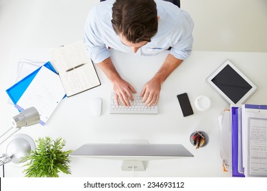 Overhead View Of Businessman Working At Computer In Office