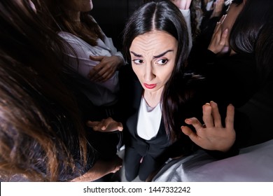 Overhead View Of Businesswoman Suffering From Claustrophobia In Crowded Elevator